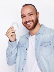 man smiling with Invisalign SMALL