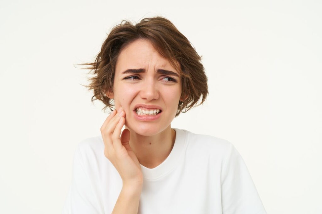 close-up-woman-has-tooth-decay-touching-cheek (Medium)