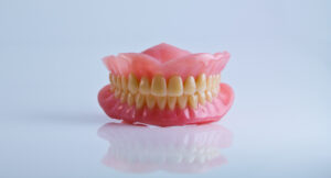 tooth plate denture on blue background