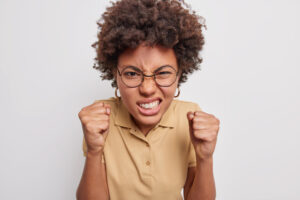 woman clenching grinding her teeth hard