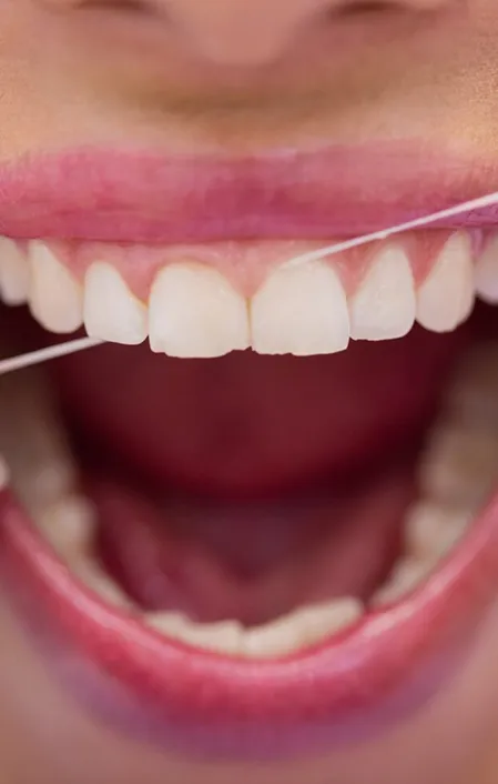 patient with gum disease flossing teeth close-up