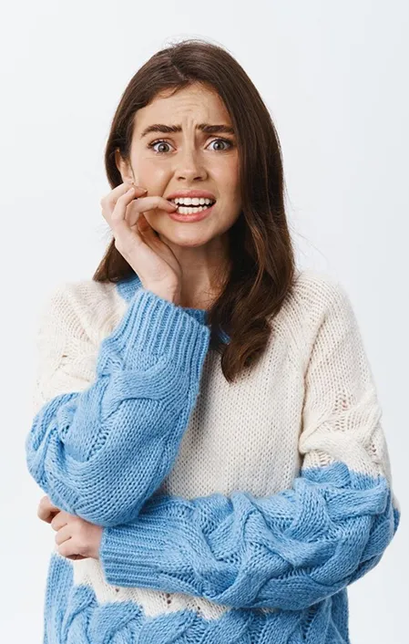 woman biting her nails due to sensitive teeth wearing down teeth