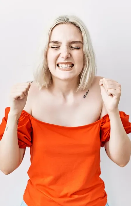 woman in red grinding her teeth