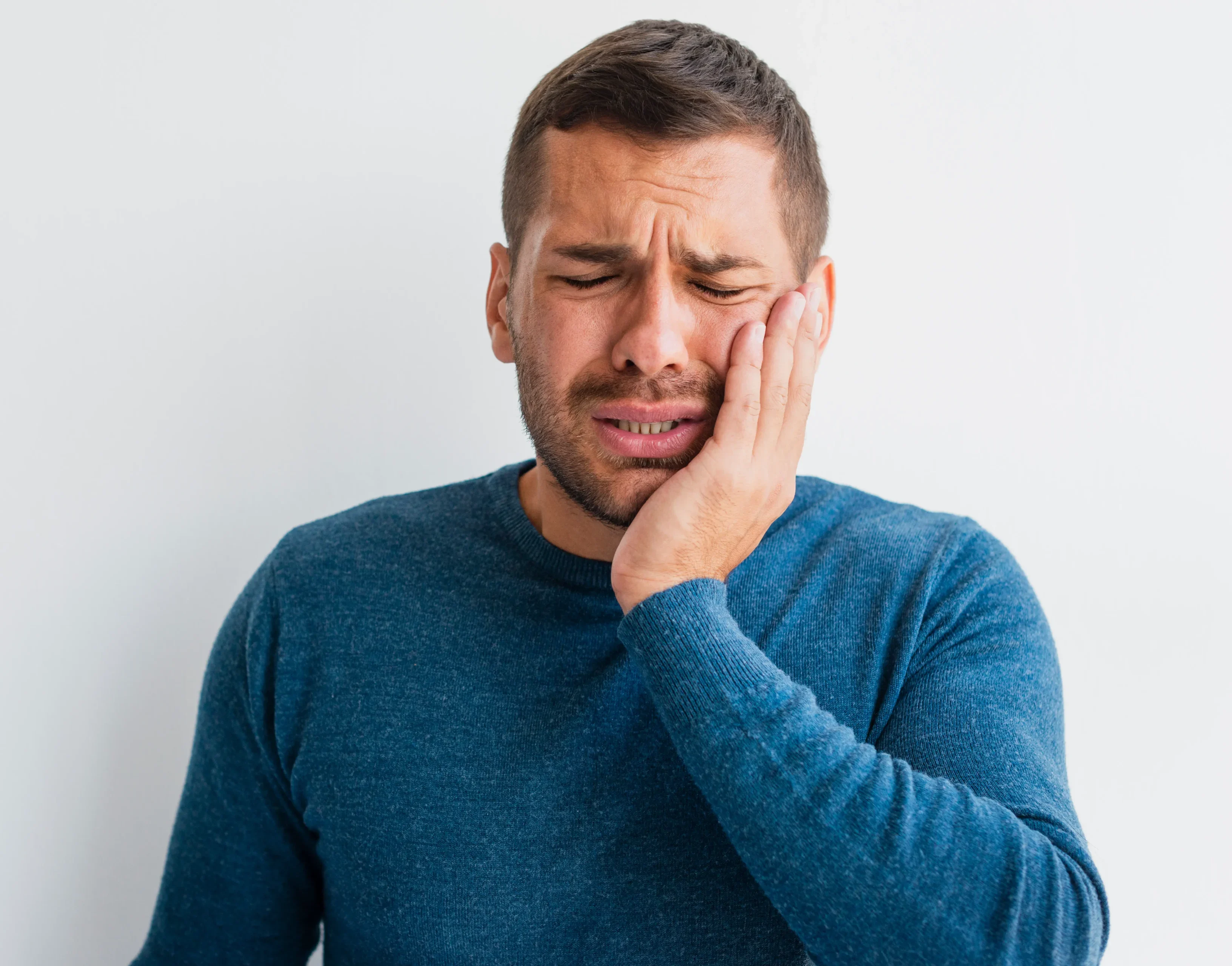 Man With Pain Holding One Hand Face needs wisdom tooth removal